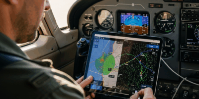 pilot in cockpit using ipad with ai flight planning app show 20260331 130550