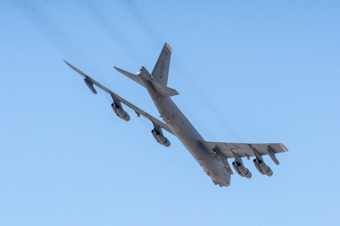 B-52H Stratofortress strategic bomber flying overhead showing the eight-engine configuration that contrasts with the B-2 two-crew design